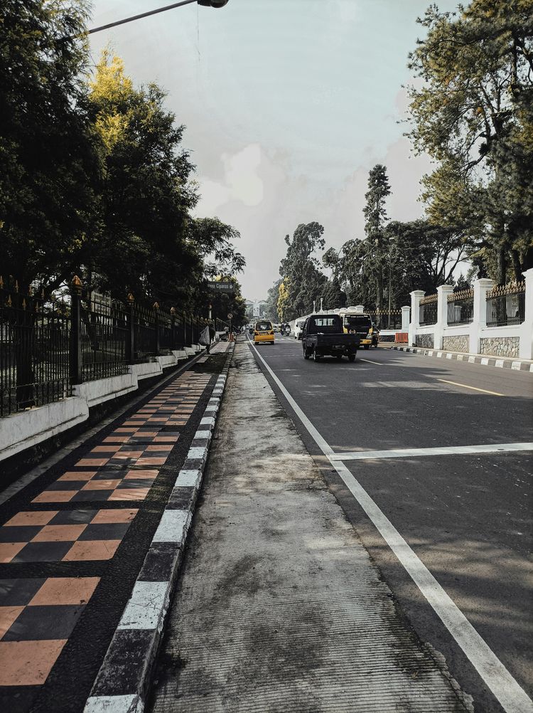 a city street with cars driving down it