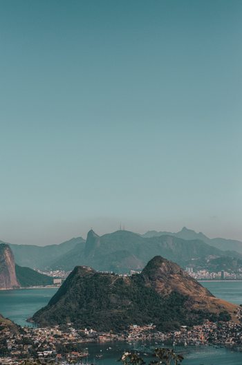 brown rock formation on body of water during daytime