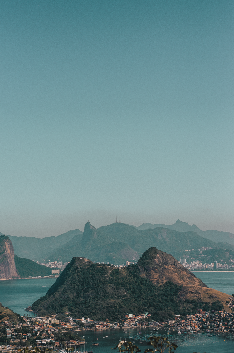 brown rock formation on body of water during daytime