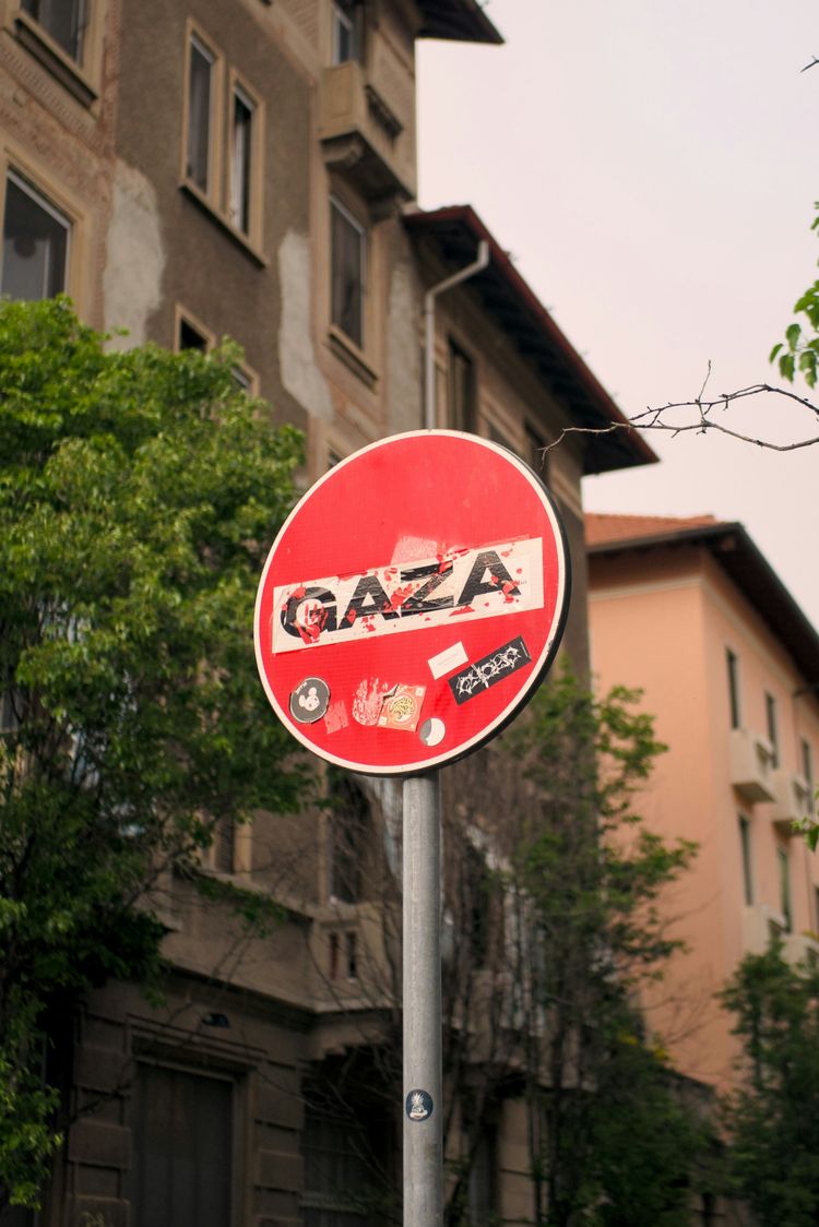 a red street sign sitting on the side of a road