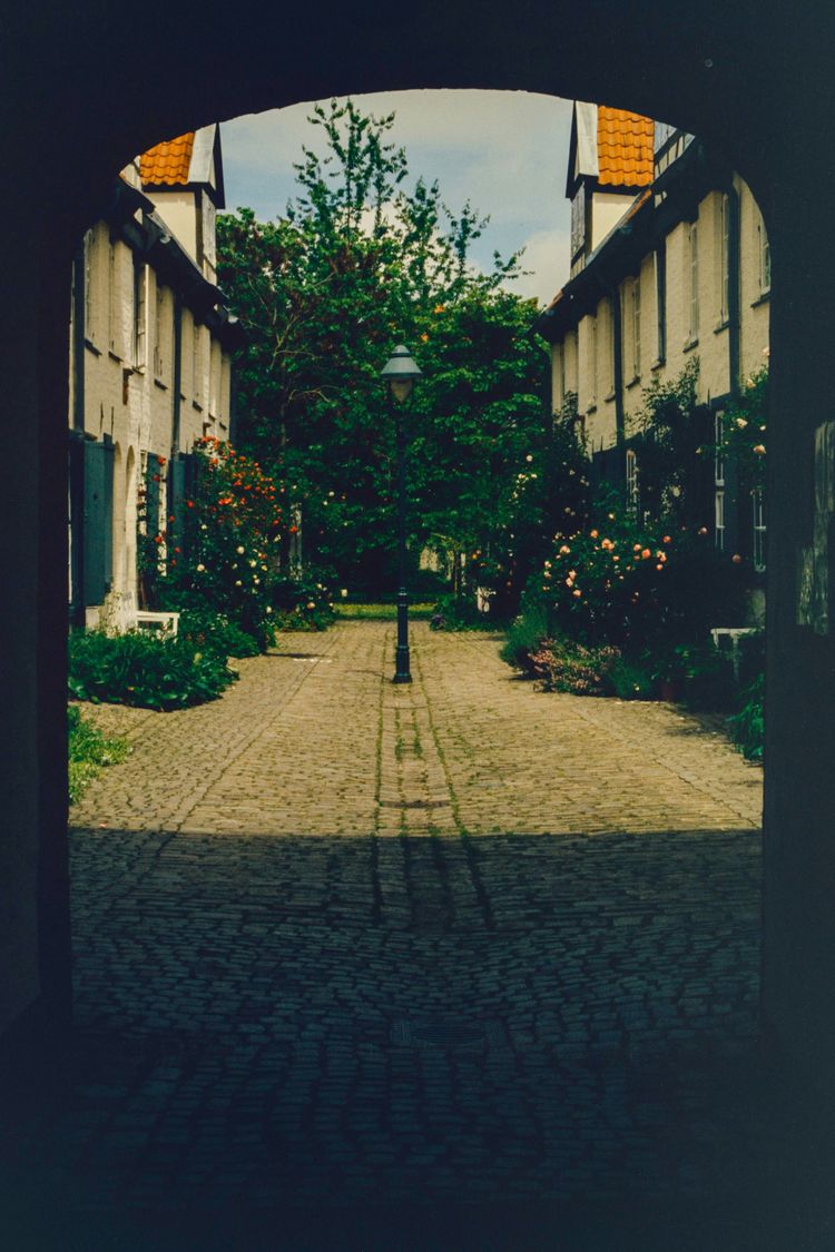 A view of a street through an arch in a building