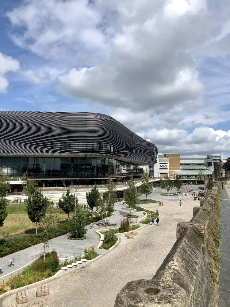 brown and white concrete building under white clouds during daytime