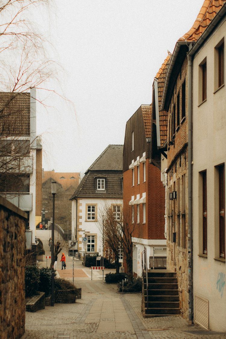 a person walking down a cobblestone street