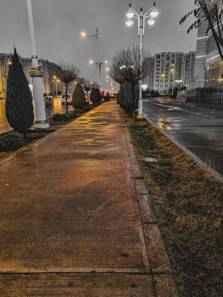 an empty street at night with street lights