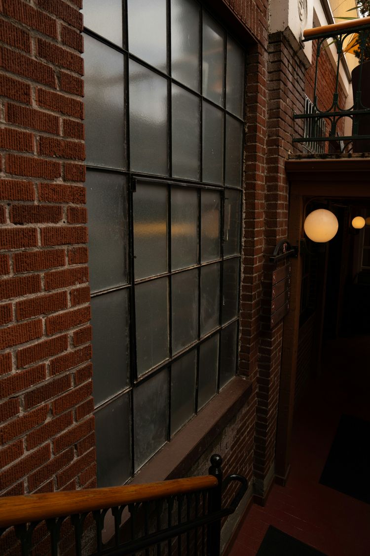 A brick building with a window and a balcony