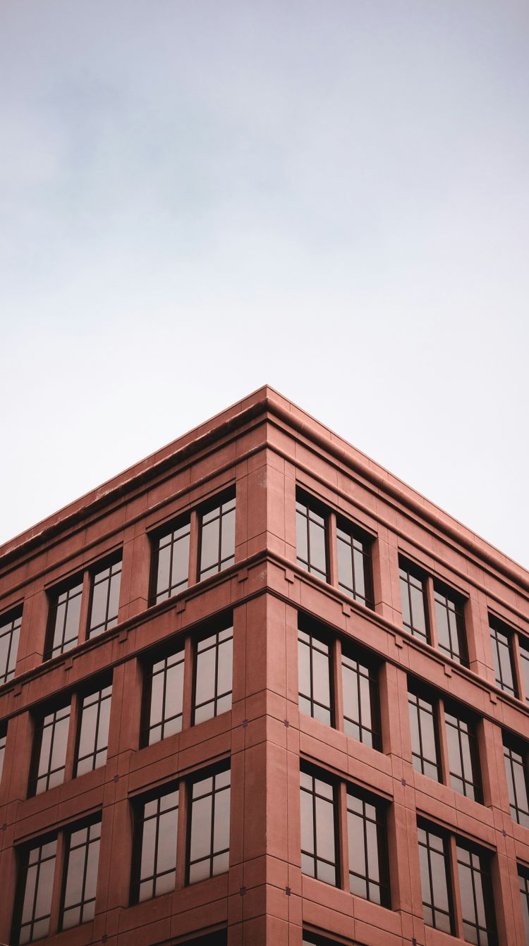 a tall red building with lots of windows