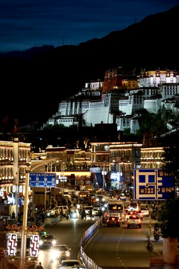a night view of a city with a mountain in the background