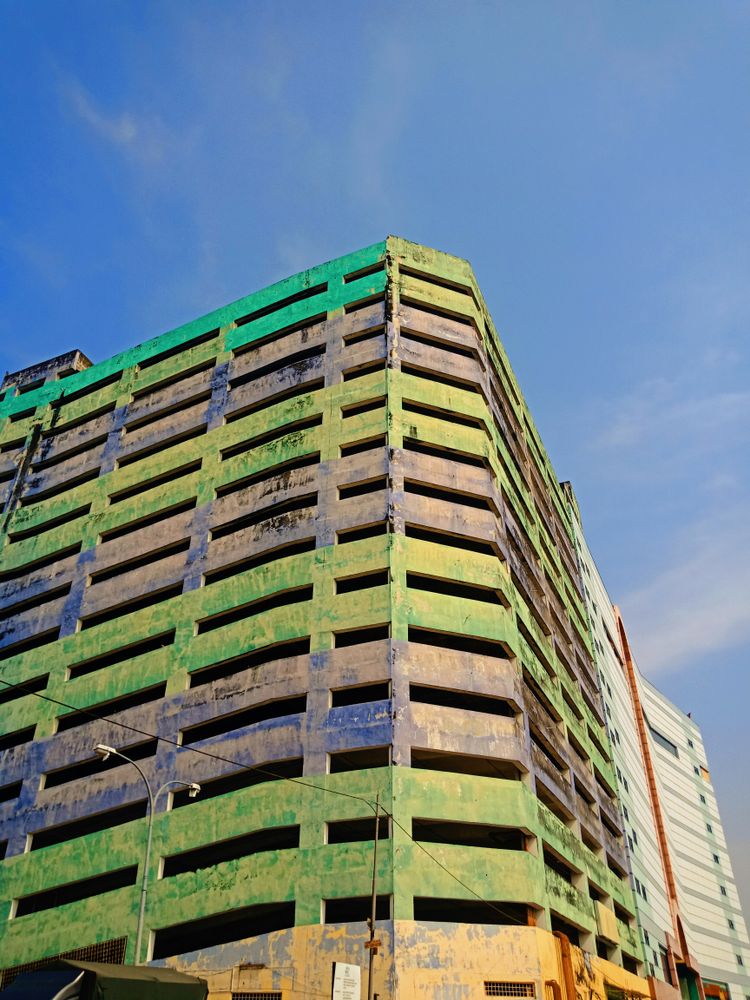 green and white concrete building under blue sky during daytime