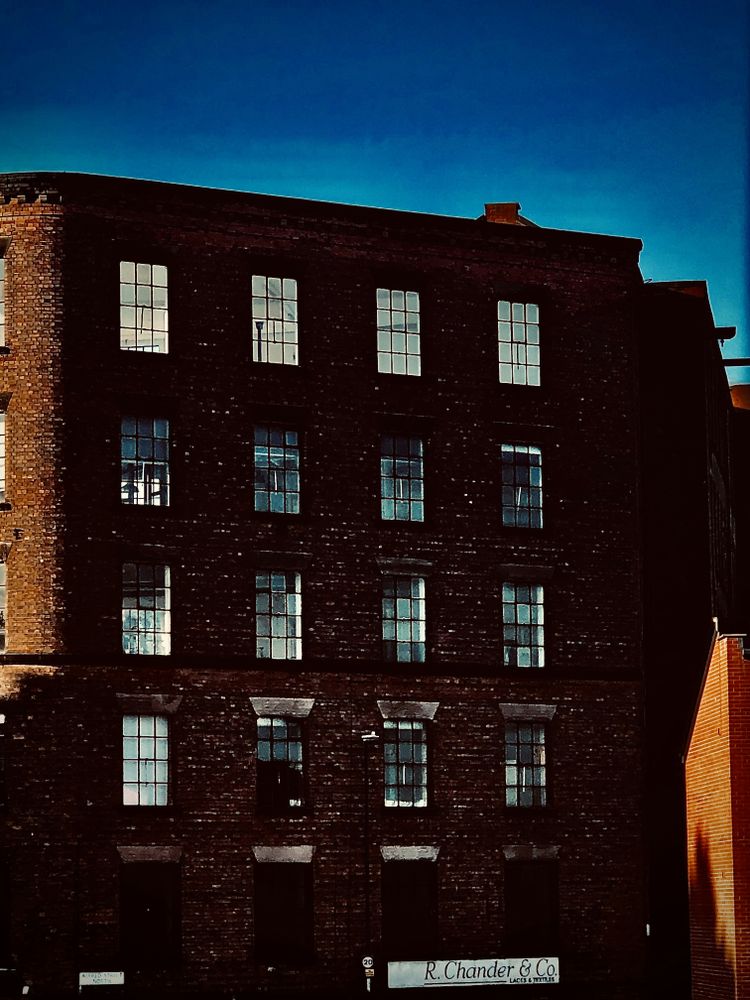 A tall brick building with lots of windows