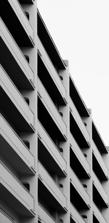 a black and white photo of a building with balconies