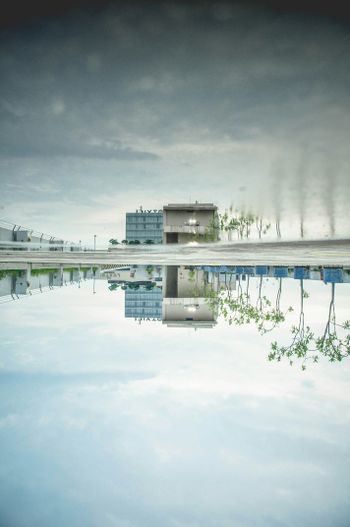 a reflection of a building in a pool of water