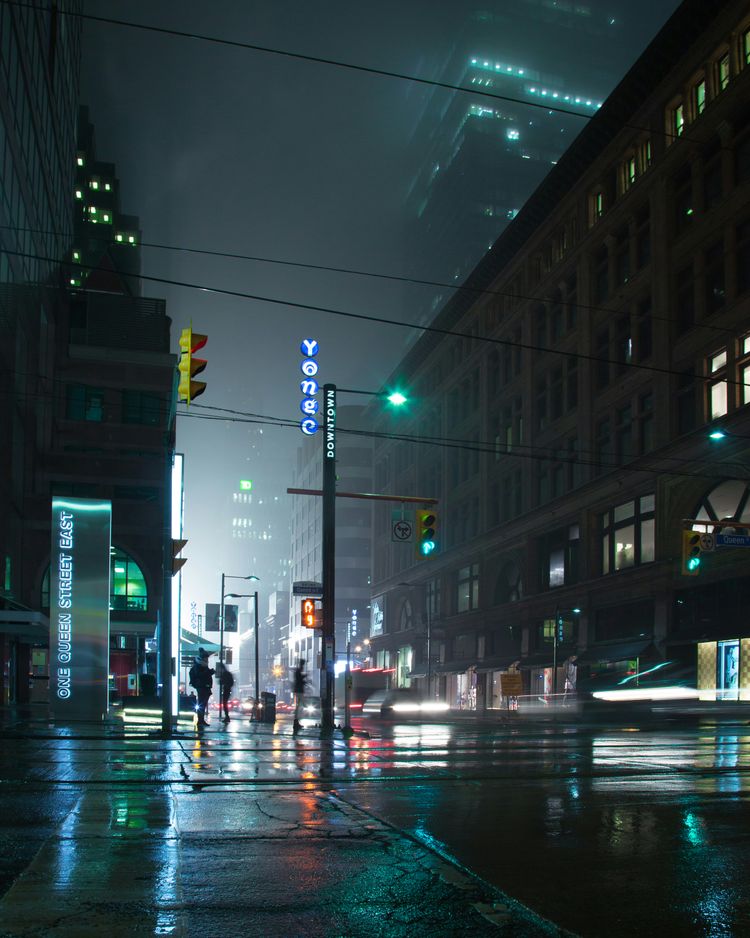 people standing near lamp post and building