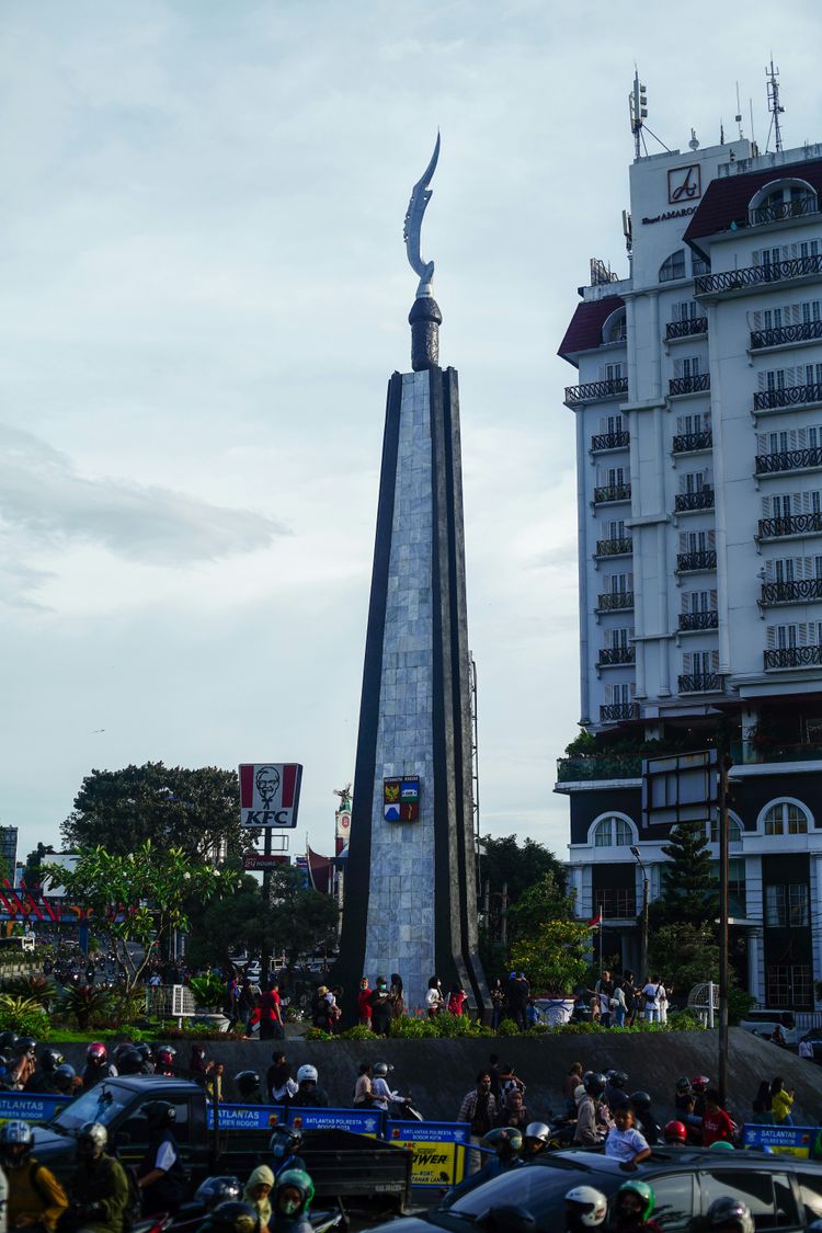 a tall monument with a bird on top of it