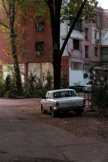 a white car parked in front of a building