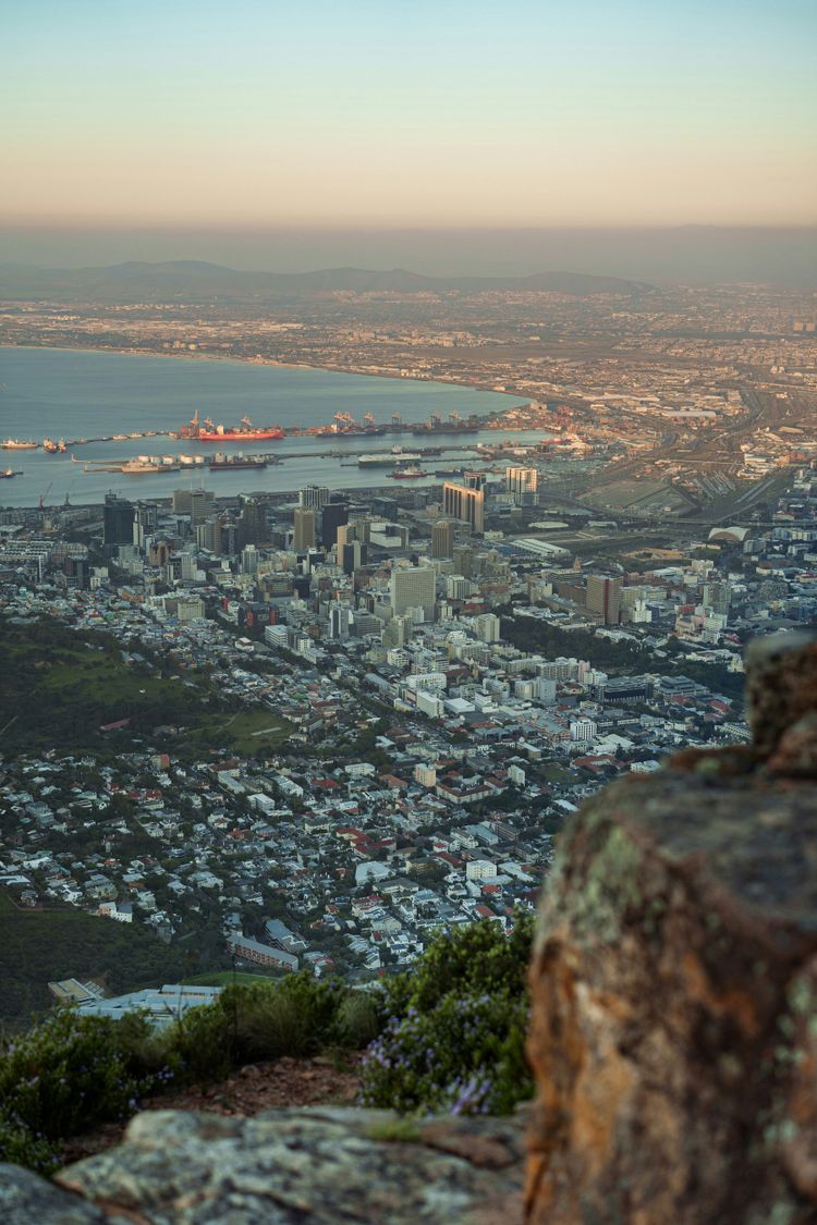 A view of a city from the top of a mountain