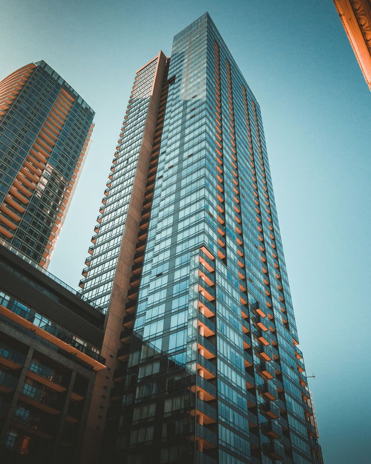 clear glass tower building on blue sky