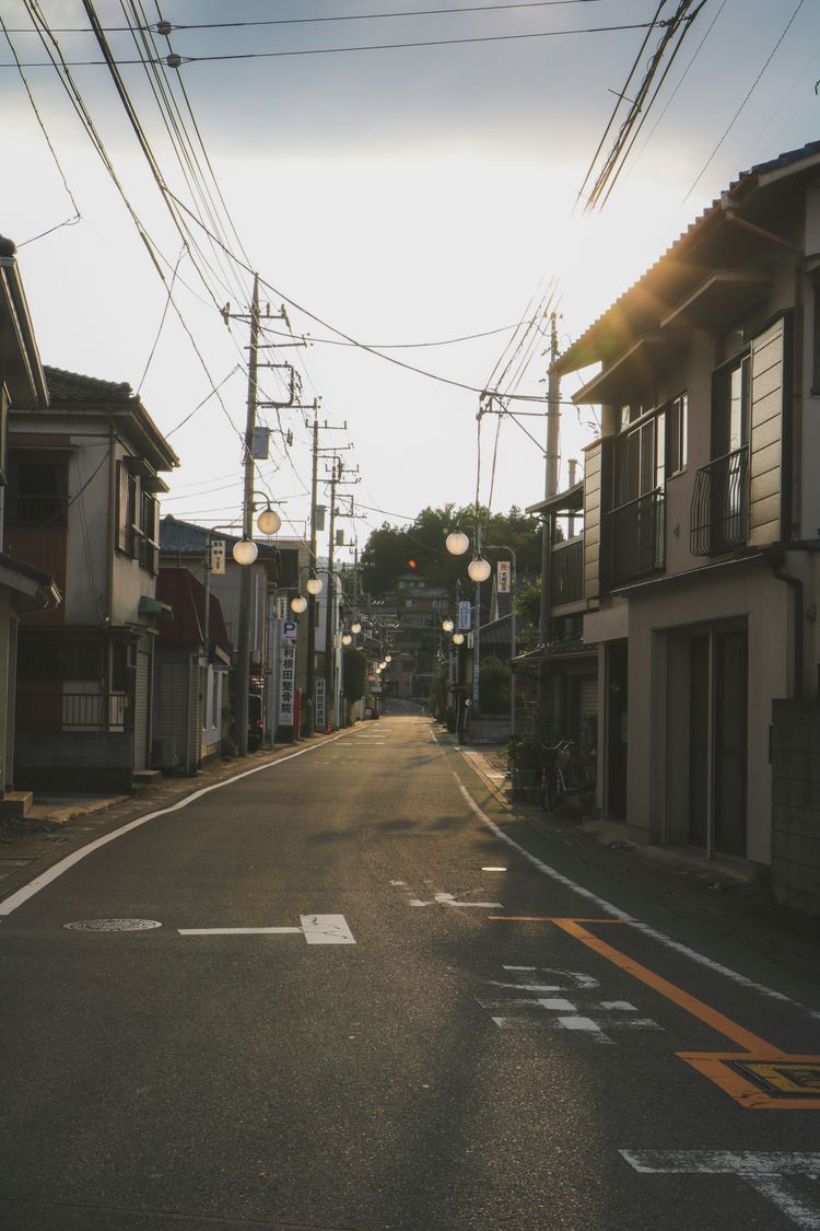 gray concrete road between buildings during daytime