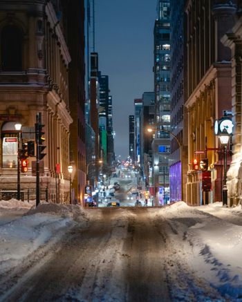 a city street is covered in snow at night