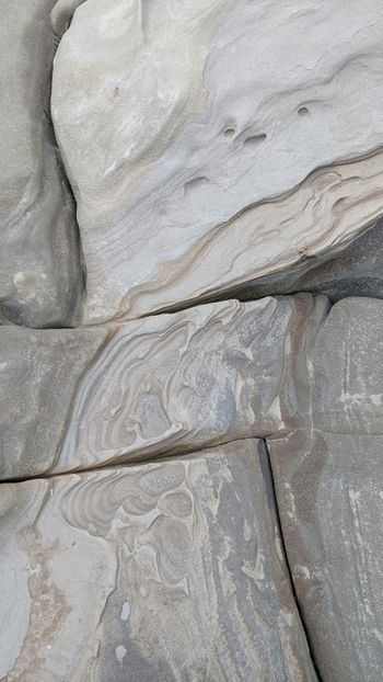 a bird is perched on a rock formation