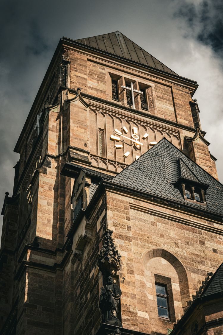 a tall brick building with a clock on it's side