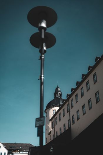 a street light with a building in the background