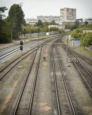 a view of a train track with buildings in the background