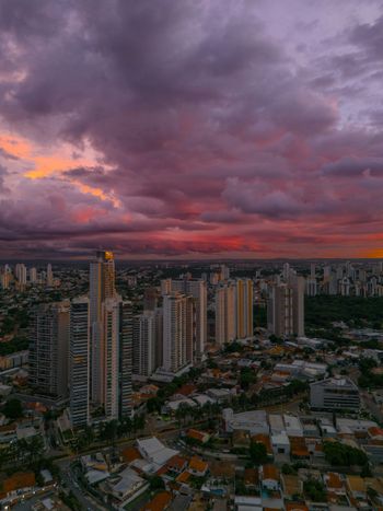 a city with tall buildings under a cloudy sky