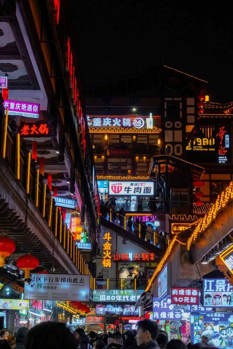 a city street filled with lots of neon signs