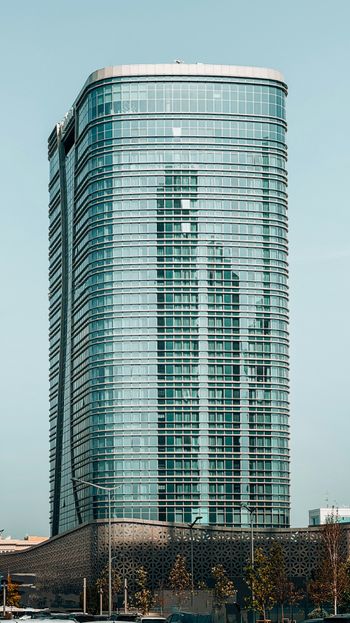 a very tall building sitting next to a body of water