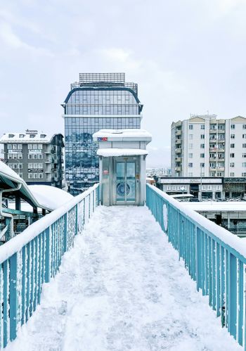 a walkway in the snow leading to a building