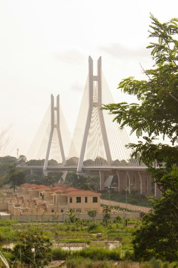 a large bridge spanning over a lush green field