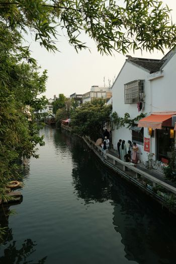 A narrow waterway with people walking down it