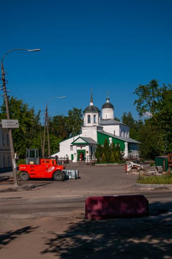 a red truck is parked in front of a church