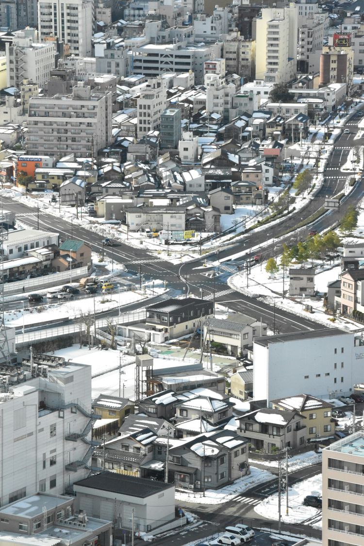 a view of a city with a train on the tracks