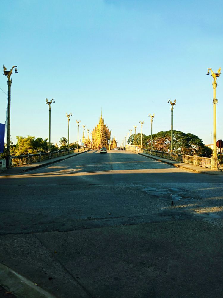 an empty street with street lamps on either side