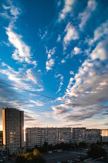 white clouds over city buildings during daytime