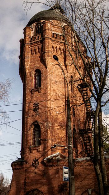 a tall brick tower with a clock on it's side