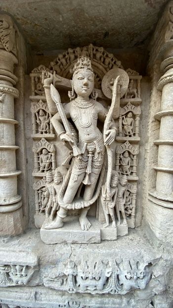 a statue of a man holding a staff