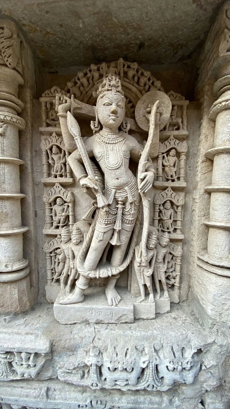 a statue of a man holding a staff
