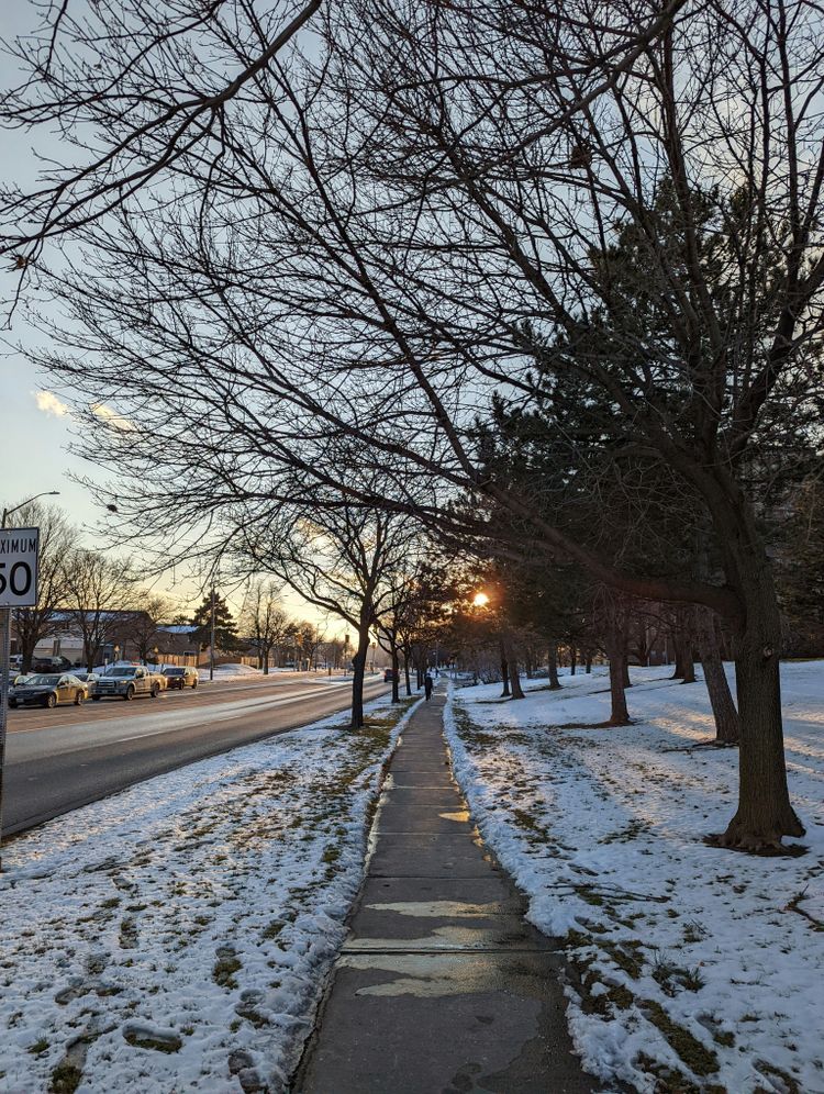 a sidewalk that has snow on the ground