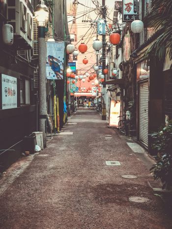 a narrow city street lined with shops and stores