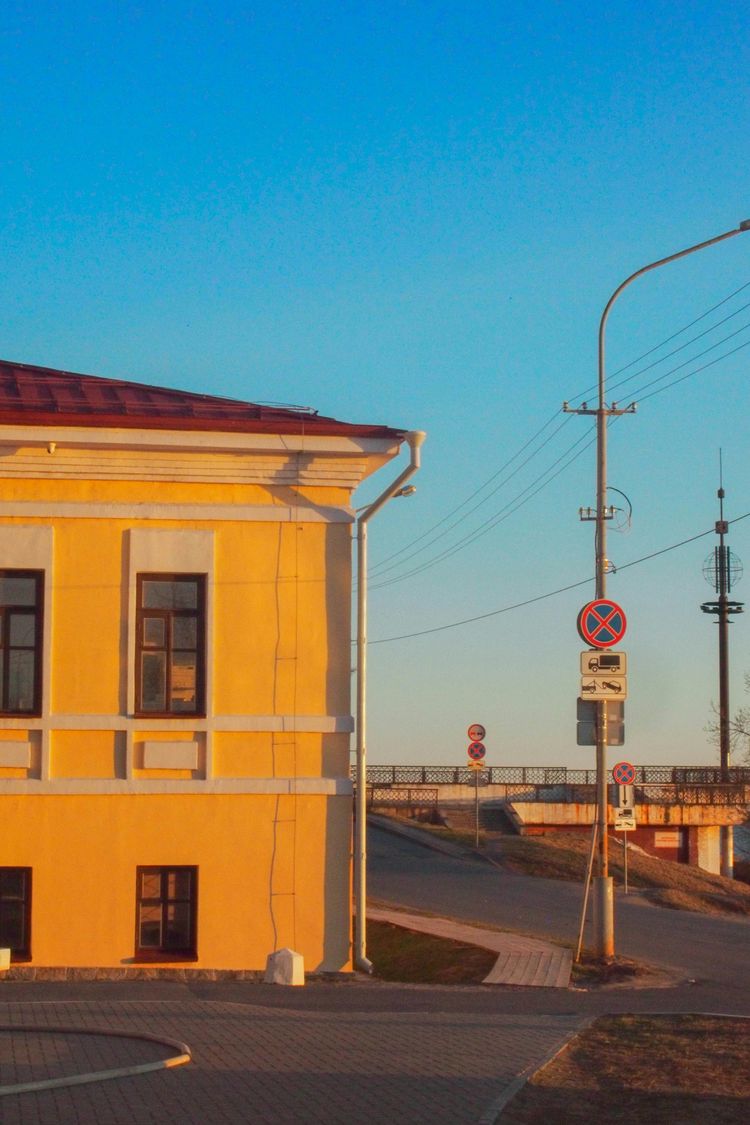 A yellow building sitting on the side of a road