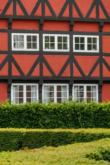 a red building with black trim and white windows