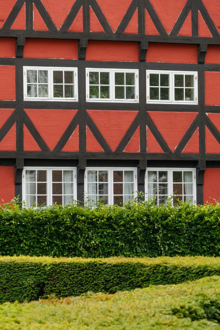 a red building with black trim and white windows