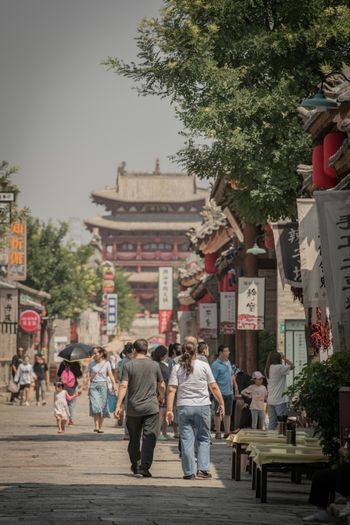 people walking on a sidewalk