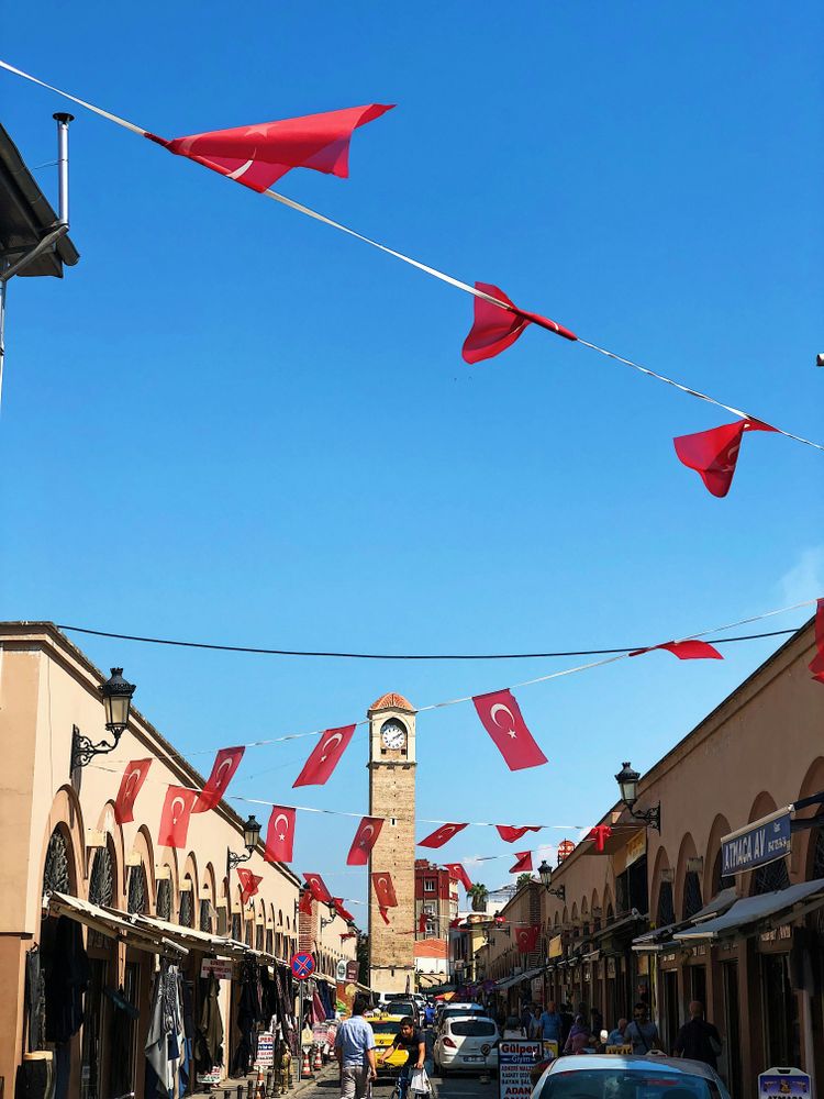 a city street with a clock tower in the background