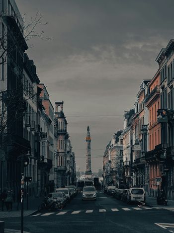 A city street with cars parked on both sides of it