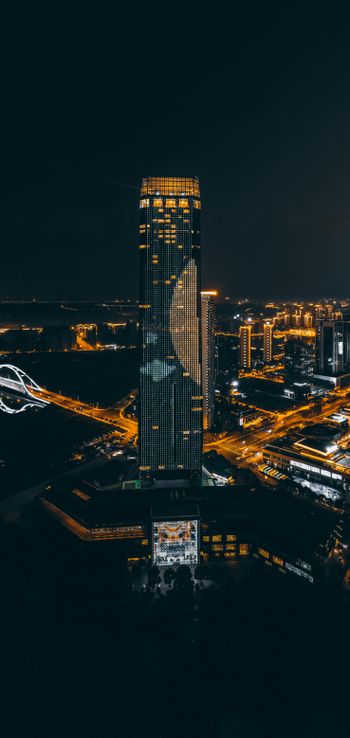 a tall building in a city at night