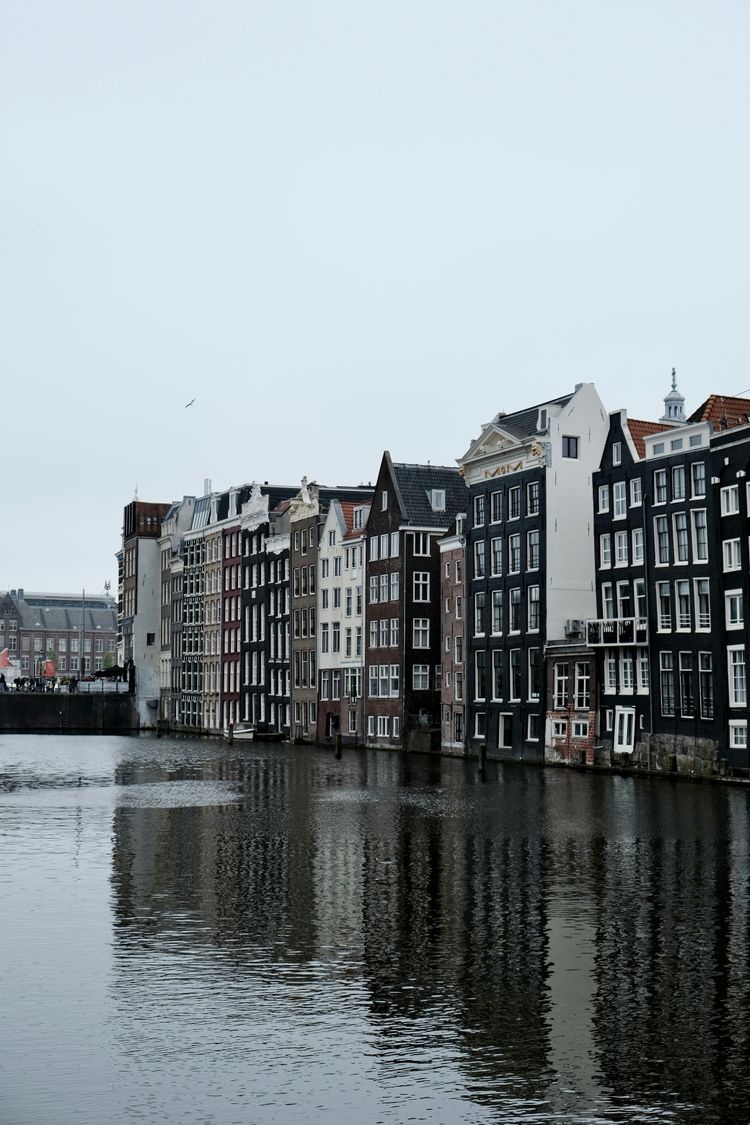 a row of buildings next to a body of water