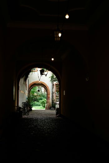 a dark hallway with a light at the end of it